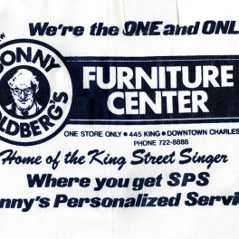 Ad for Sonny Goldberg's Furniture Center stenciled on souvenir apron